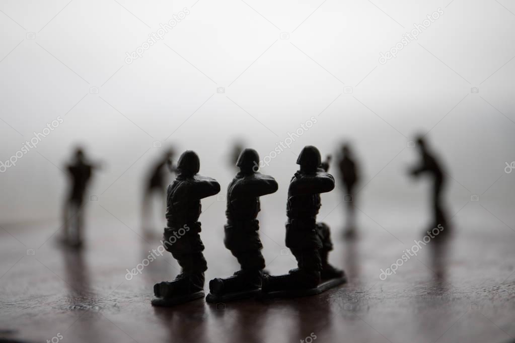 miniature toy soldiers and tank on board. Close up image of toy military at war.