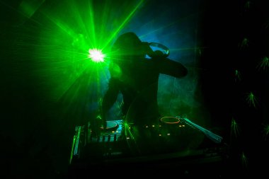 DJ iplik, karıştırma ve bir gece kulübünde tırmalamak, dj elinde çeşitli parça denetimlere dj's güverte, strobe ışıklar ve sis oynamak veya parti gece kulübünde parça Dj karışımları