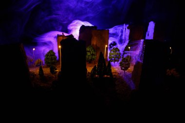 Gece yoğun sis içinde şehir. Kalın duman karanlık bir sokakta. Adam yolda siluetleri. Masa dekorasyonu. Seçici odak