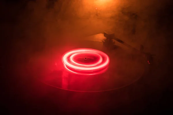 ターン テーブル ビニール レコード プレーヤー。ディスク ジョッキーのレトロなオーディオ機器。Dj ミックス ・音楽を再生するためのサウンド テクノロジー。燃焼火災の背景に対して再生されてビニール レコード — ストック写真