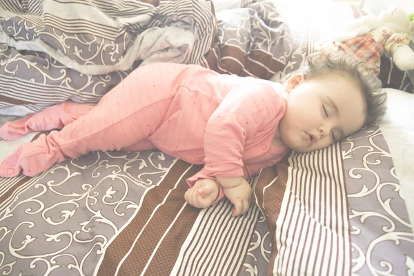 Sover barnet i sängen, 7 månader gammal baby som sover på sängen på dagtid. — Stockfoto