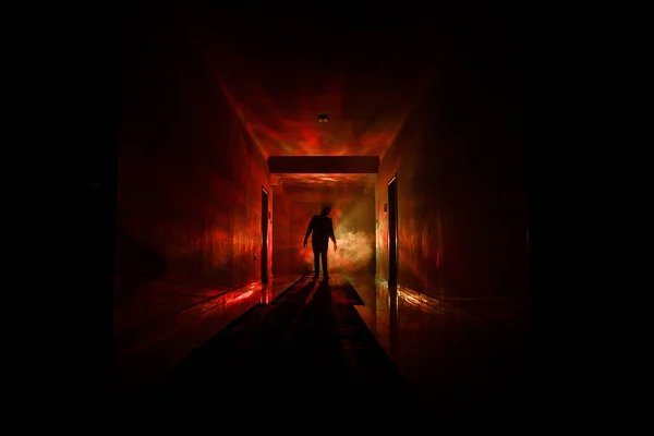 Creepy silhouette in the dark abandoned building. Dark corridor with cabinet doors and lights with silhouette of spooky horror person standing with different poses.