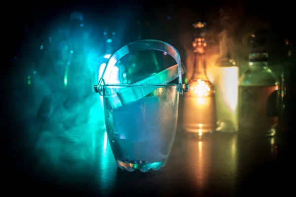 Cubo Hielo Vidrio Botellas Alcohol Borrosas Fondo Con Luces Humo —  Fotos de Stock