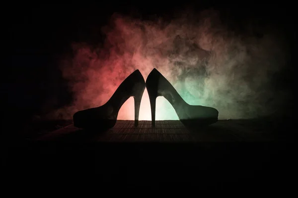 Black suede high heel women shoes on dark toned foggy background. Close up. Women power or women domination concept. — Stock Photo, Image