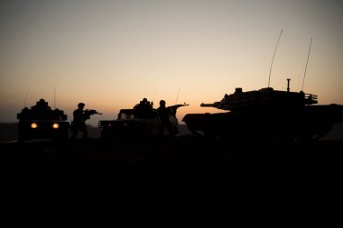 Gün batımı arka plan üzerinde askeri devriye arabası. Ordu savaş kavramı. Askerler saldırmaya hazır ile zırhlı araç silüeti. Resim dekorasyon. Seçici odak