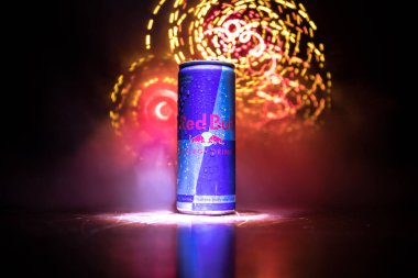 BAKU, AZERBAIJAN - April 20, 2018: Red Bull classic 250 ml can on dark toned foggy background. Red Bull is an energy drink sold by Austrian company clipart