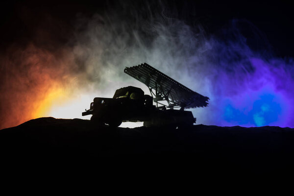 Rocket launch with fire clouds. Battle scene with rocket Missiles with Warhead Aimed at Gloomy Sky at night. Soviet rocket launcher on War Background.