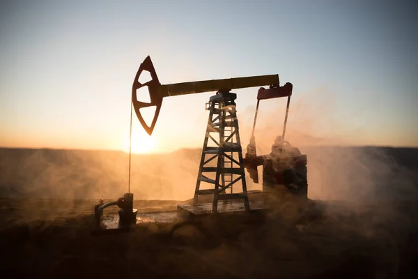 Decoração de arte criativa. Bomba de óleo e fábrica de refino de óleo ao pôr do sol. Conceito industrial de energia. Foco seletivo . — Fotografia de Stock