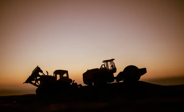 Abstract Industrial background with construction crane silhouette over amazing sunset sky. Mobile crane against the evening sky. Industrial skyline. Selective focus Stock Photo