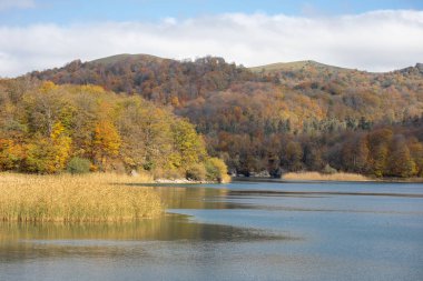 Göl ve dağlarla sakin bir akşam manzarası. Ganja, Azerbaycan 'daki renkli sonbahar ormanları arasında Goy-Gol Gölü' nün (Mavi Göl) inanılmaz manzarası.