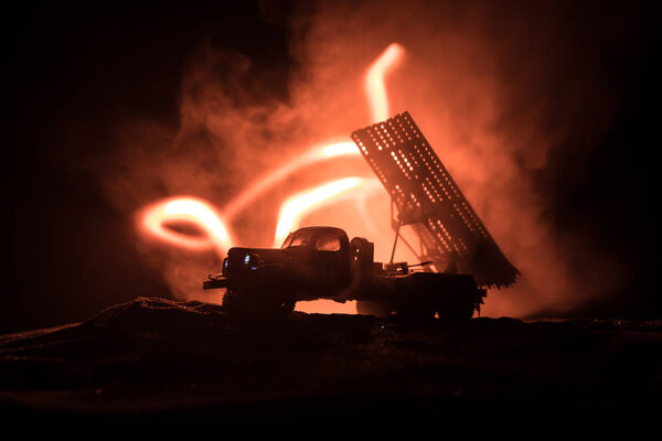Rocket launch with fire clouds. Battle scene with rocket Missiles with Warhead Aimed at Gloomy Sky at night. Soviet rocket launcher on War Background.