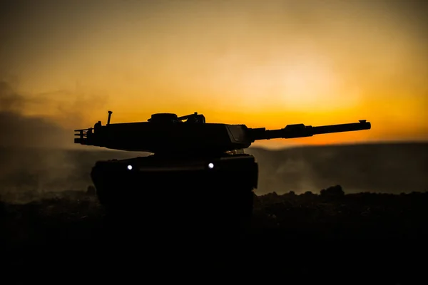 War Concept. Armored vehicle silhouette fighting scene on war fog sky background. American tank at sunset. — Stock Photo, Image
