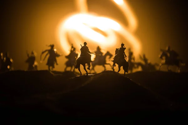 Medieval battle scene with cavalry and infantry. Silhouettes of figures as separate objects, fight between warriors on dark toned foggy background. Night scene. — Stock Photo, Image