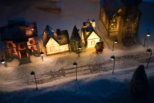 New Year miniature house in the snow at night with fir tree. — Stock Photo, Image