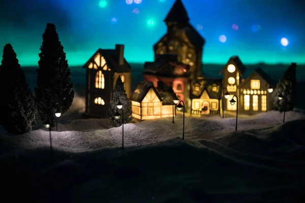 New Year miniature house in the snow at night with fir tree. — 图库照片