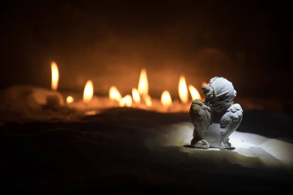 Little white guardian angel in snow. Festive background. Christmas and New Year concept. Selective focus