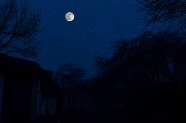 Geceleri bulutlu ve yıldızlı klasik kır evi. Soğuk sonbahar gecesi