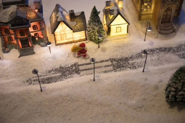 New Year miniature house in the snow at night with fir tree. — 图库照片