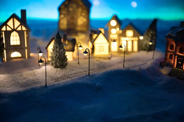New Year miniature house in the snow at night with fir tree. — 图库照片