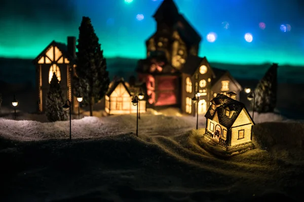 New Year miniature house in the snow at night with fir tree. — 图库照片