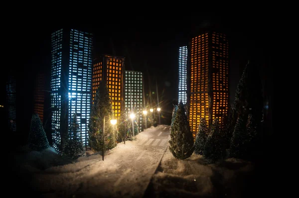 New Year miniature house in the snow at night with fir tree. Holiday concept. Selective focus — Stock Photo, Image