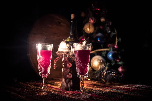 stock image Red wine in crystal glass with bottle on colorful carpet with creative New Year artwork decorations. Copy space