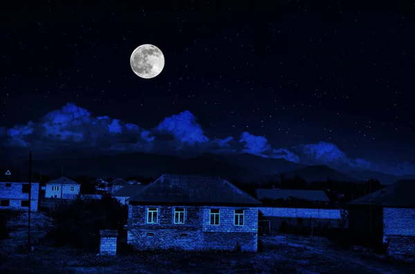 Vintage country house at night with clouds and stars. Cold autumn night