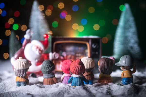 Christmas decoration with burning candles on a dark background. Christmas ornaments over dark golden background with lights. Creative artwork decoration.