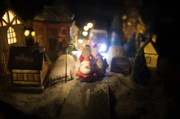 New Year miniature house in the snow at night with fir tree. Holiday concept. Selective focus — Stock Photo, Image