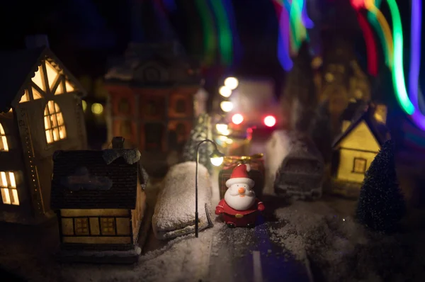 New Year miniature house in the snow at night with fir tree. Holiday concept. Selective focus — Stock Photo, Image