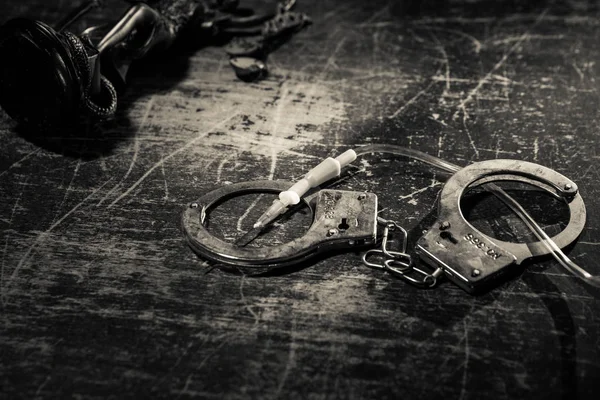 Prisoner handcuffed to death by lethal injection, vial with sodium thiopental and syringe on top of a table, conceptual image — Stock Photo, Image