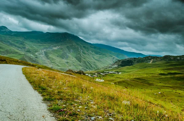 Cycling mountain road. Misty mountain road in high mountains.. Cloudy sky with mountain road