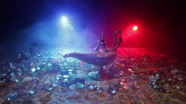 Lamp of wishes concept. Silhouette of a man standing in the middle of the road on a misty night with giant Antique Aladdin arabian nights genie style oil lamp. Creative artwork decoration