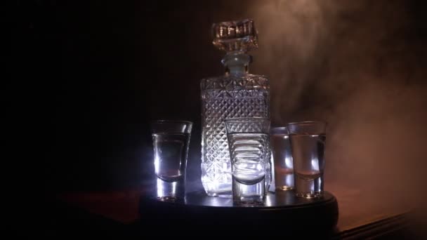 Beautiful Carafe Vodka Stands Wooden Table Glasses Dramatic Toned Foggy — Stock Video