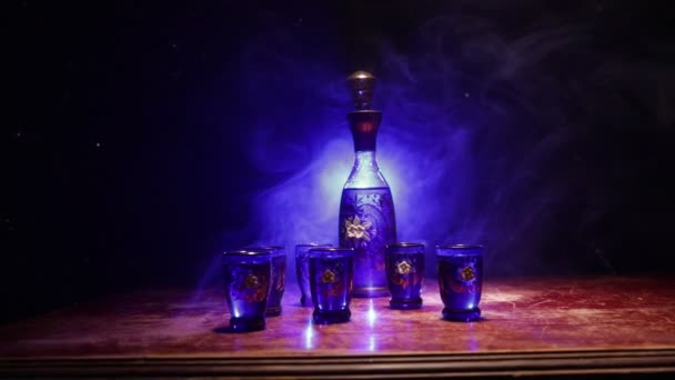 Beautiful Blue Carafe Vodka Stands Wooden Table Glasses Dramatic Toned — ストック動画