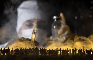 Woman doctor in mask holding syringe and standing against crowd. Virus, outbreak and mass disease, Corona virus concept. Selective focus. Creative artwork decoration clipart