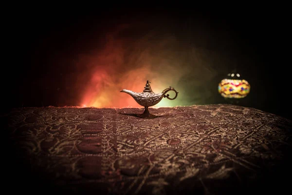 Antique Aladdin arabian nights genie style oil lamp with soft light white smoke, Dark background. Lamp of wishes concept