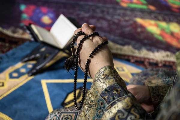 Muslim woman praying for Allah muslim god at the mosque. Hands of muslim woman on the carpet praying in traditional wearing clothes, Woman in Hijab.