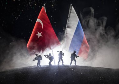 Russia and Turkey small flag on dark background. Concept of crisis of war and political conflicts between nations. Selective focus clipart