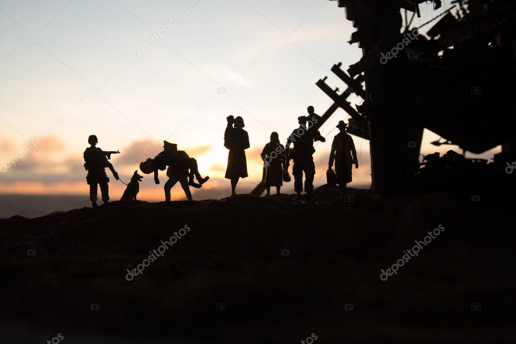 Refugees and captive walking in destroyed city. Terrible face of war concept. Creative artwork table decoration with light and fog. Selective focus.