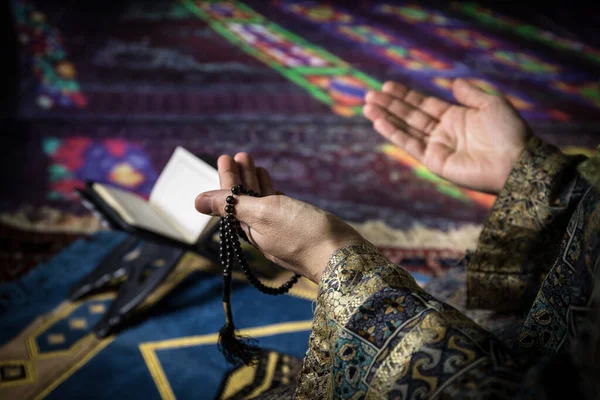 Muslim woman praying for Allah muslim god at the mosque. Hands of muslim woman on the carpet praying in traditional wearing clothes, Woman in Hijab.