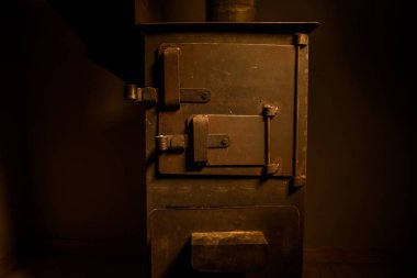 Küçük siyah demir sobada ateş yanıyor. Geleneksel Azerbaycan ceviz sobası. Seçici odaklı yakın plan fotoğraf