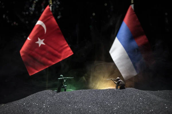 Russia and Turkey small flag on dark background. Concept of crisis of war and political conflicts between nations. Selective focus