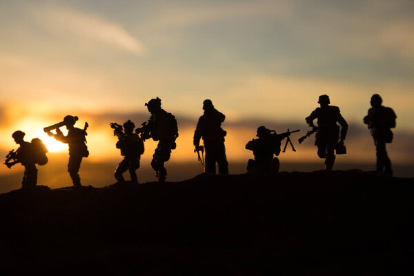 War Concept. Military silhouettes fighting scene on war fog sky background, World War Soldiers Silhouette Below Cloudy Skyline sunset. Selective focus