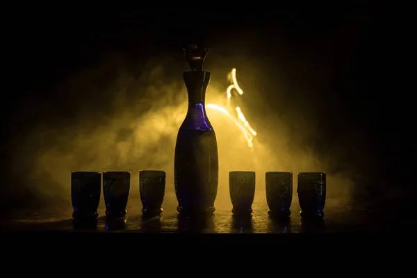 Beautiful Blue Carafe Vodka Stands Wooden Table Glasses Dramatic Toned — ストック写真