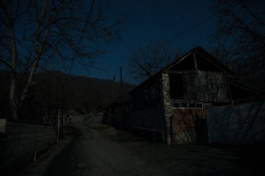 Gece sessiz köyde dolunay var. Ay ışığı altındaki dağ köyünün güzel gece manzarası. Azerbaycan doğası. Uzun pozlu çekim