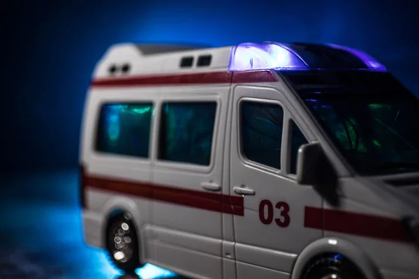 Corona virus concept with Ambulance car. Stay home for precautionary measures to prevent from corona virus. Ambulance car on dark misty background. Creative artwork decoration. Selective focus