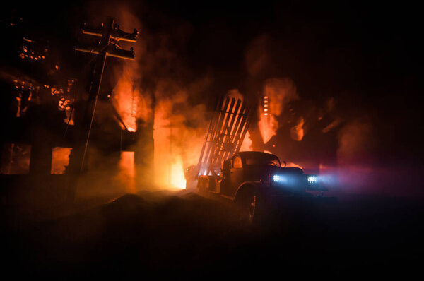 Rocket launch with fire clouds. Battle scene with rocket Missiles with Warhead Aimed at Gloomy Sky at night. Soviet rocket launcher on War Background. Creative composition.
