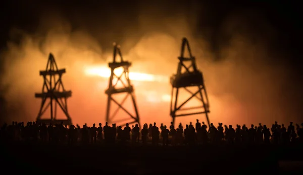 Oil industry crisis concept. Oil stock crisis because Covid global pandemic. Oil pump and oil refining factory at night with fog and backlight. Creative artwork decoration. Selective focus.