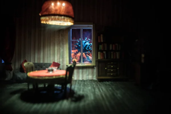 A realistic dollhouse living room with furniture and window at night. Stay home stay safe coronavirus concept. Selective focus.